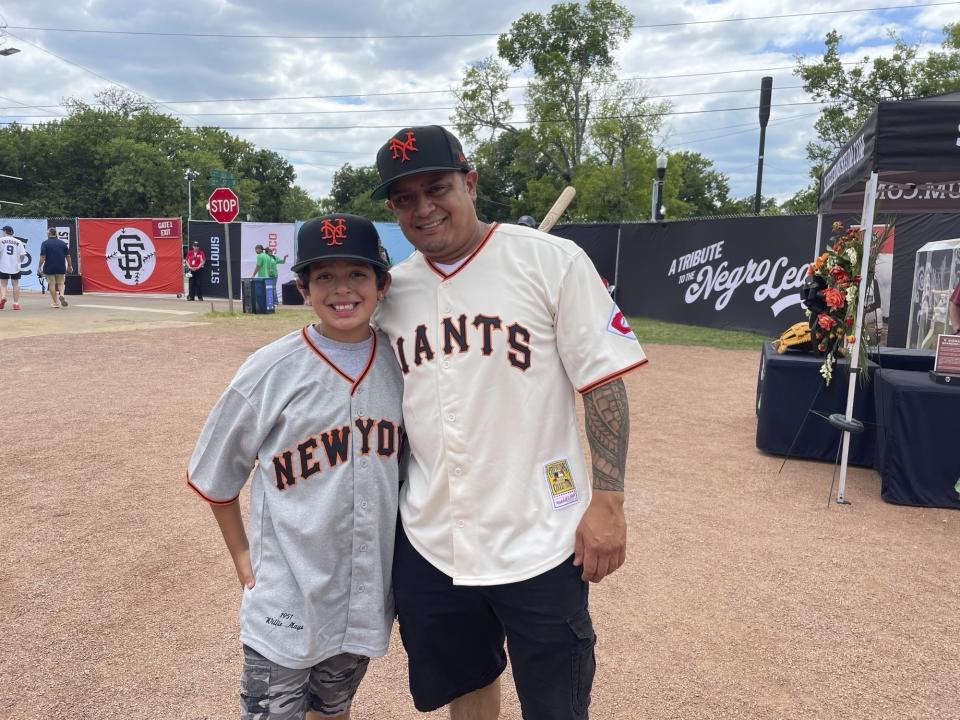 Eddie Torres, right, and son Junior, from California and wearing San Francisco Giants uniforms with Willie Mays' No. 24 on the back, pose at Rickwood Field on Thursday, June 20, 2024, in Birmingham, Ala. (AP Photo/Alanis Thames)