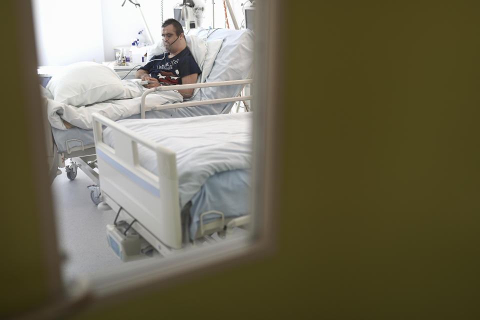 A patient lies on a bed at the COVID-19 ICU unit of the Dr. Abdulah Nakas General Hospital in Sarajevo, Bosnia, Friday, Sept. 24, 2021. Public mistrust of authorities in corruption-plagued Bosnia has created an opening for anti-vaccination movement even though the Balkan nation has the highest rate in Europe of coronavirus deaths and faces a growing number of new infections. So far, despite an abundance of coronavirus vaccines in Bosnia, just under 13 percent of its 3.3 million people had been fully immunized against Covid-19. (AP Photo)