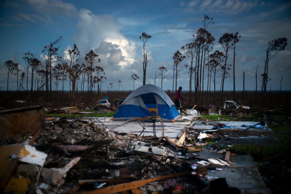 A man searches in the rubble of his house destroyed by Hurricane Dorian in Rocky Creek East, Grand Bahama, Bahamas, Thursday Sept. 12, 2019. 