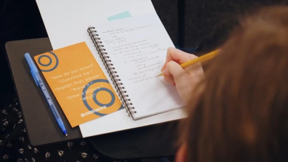 A Success Academy student takes notes in class. Success Academy, New York City’s largest charter school network, is at the center of a former staffer’s $64 million lawsuit alleging systemic racial discrimination. (Photo: Screenshot/YouTube.com/Success Academies)