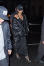 <p> She amps up her simple black slip with an oversized shearling coat and fishnet tights. </p>