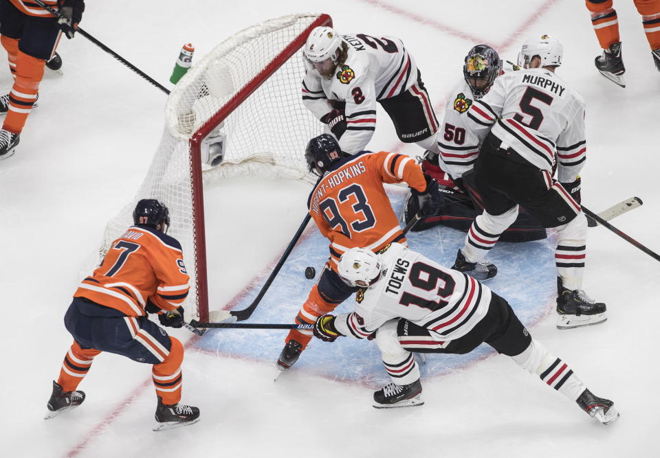 Edmonton Oilers scramble in front of the Chicago Blackhawks net during the third period of an NHL hockey playoff game in Edmonton, Alberta, Saturday, Aug. 1, 2020. (Jason Franson/The Canadian Press via AP)