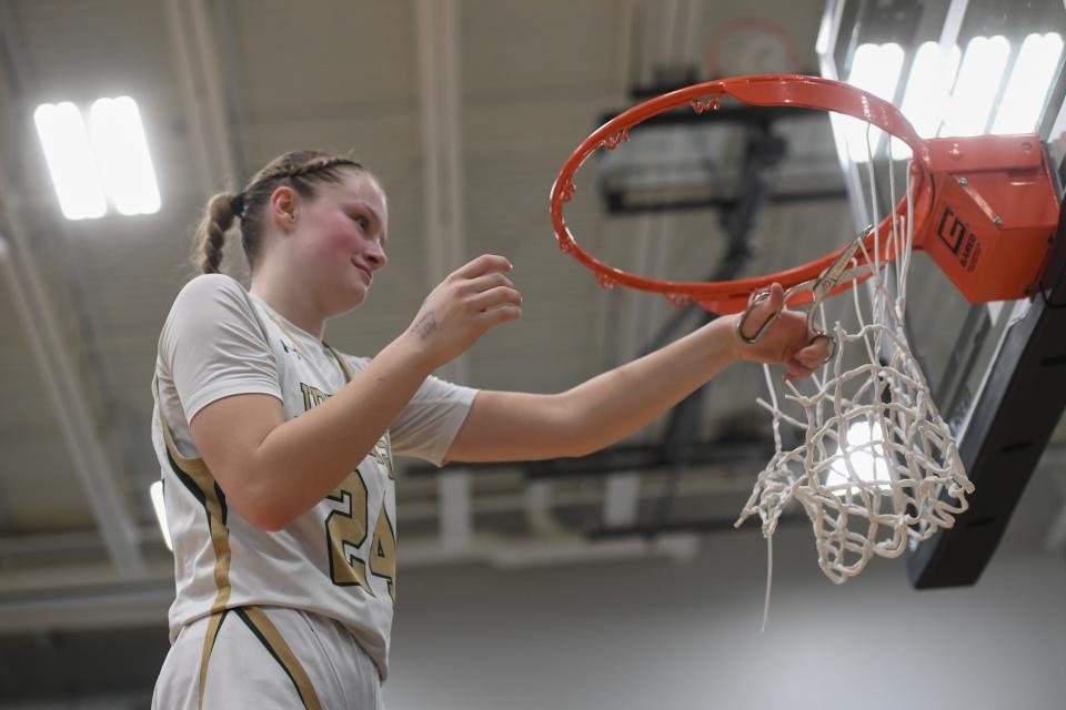 Jefferson’s guard Brinley Altenburg (24) cuts the net after winning SoDak 16 game with her team on Friday, March 1, 2024 at Jefferson High School in Sioux Falls.
