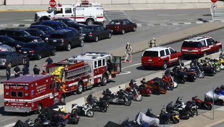 Emergency workers, a few in hazmat suits, conduct their work in a Pentagon parking lot after a woman who recently traveled to Africa vomited there, in Washington October 17, 2014. REUTERS/Kevin Lamarque
