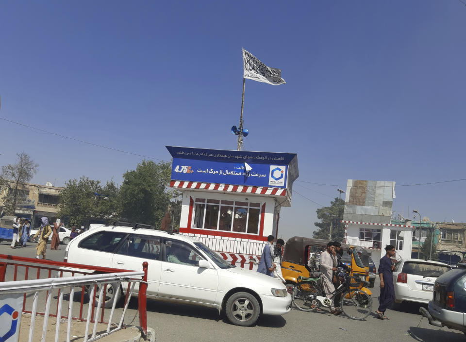 A Taliban flag flies in the main square of Kunduz city after fighting between Taliban and Afghan security forces, in Kunduz, Afghanistan, Sunday, Aug. 8, 2021. Taliban fighters Sunday took control of much of the capital of northern Afghanistan's Kunduz province, including the governor's office and police headquarters, a provincial council member said. (AP Photo/Abdullah Sahil)