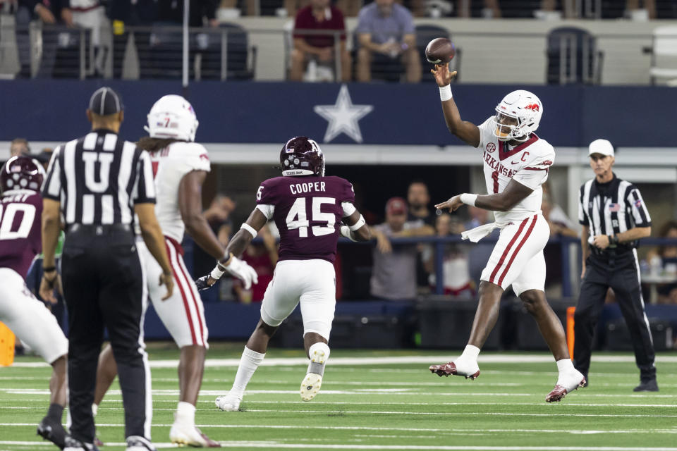 Arkansas quarterback KJ Jefferson (1) throws a pass as Texas A&M linebacker Edgerrin Cooper (45) defends during the first half of an NCAA college football game Saturday, Sept. 24, 2022, in Arlington, Texas. (AP Photo/Brandon Wade)