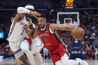 New Orleans Pelicans guard CJ McCollum (3) drives to the basket against Oklahoma City Thunder guard Shai Gilgeous-Alexander (2) in the first half of Game 3 of an NBA basketball first-round playoff series in New Orleans, Saturday, April 27, 2024. (AP Photo/Gerald Herbert)