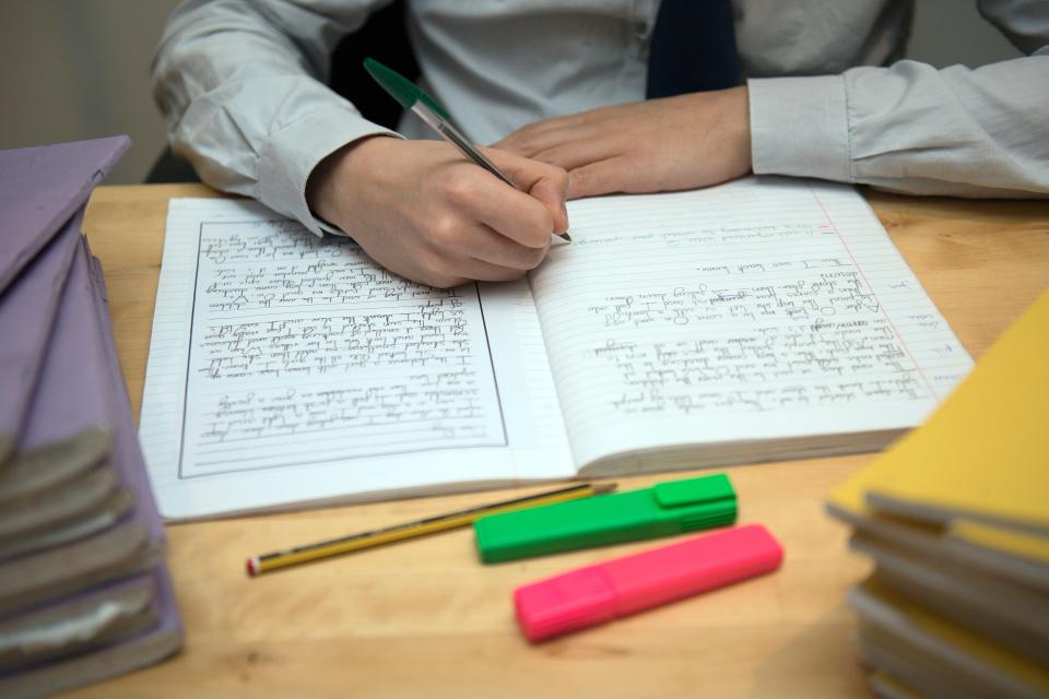 (FILE) A primary school teacher marking a pupil’s English homework (PA Archive)