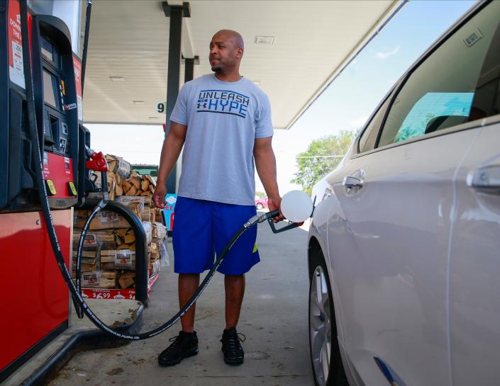 Otis Williams of Norwalk pumps $50 of fuel into his car at a gas station in Norwalk. Williams, a truck driver, says he doesn't expect the fuel prices to fall anytime soon