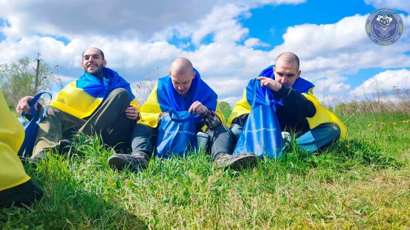 Ukrainian prisoners of war (POWs) rest after a swap at an unknown location in Ukraine