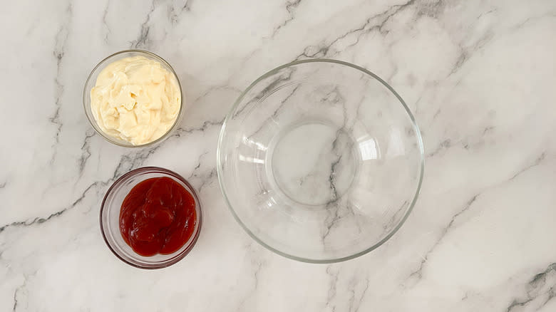 Glass bowl with mayonnaise and ketchup