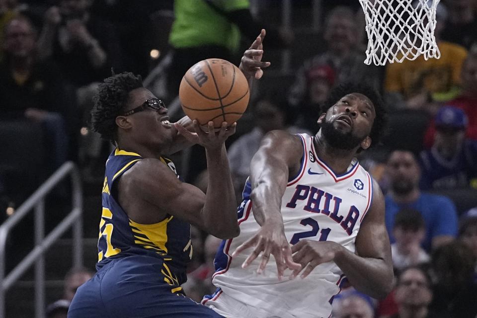 Indiana Pacers' Jalen Smith (25) is fouled by Philadelphia 76ers' Joel Embiid during the second half of an NBA basketball game, Monday, March 6, 2023, in Indianapolis. (AP Photo/Darron Cummings)