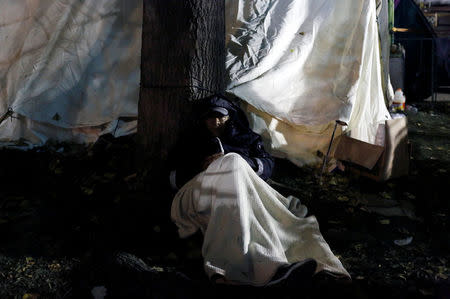 A man rests outside a tent, as he waits for news of his loved ones, next to a collapsed building, after an earthquake in Mexico City, Mexico September 25, 2017. REUTERS/Henry Romero