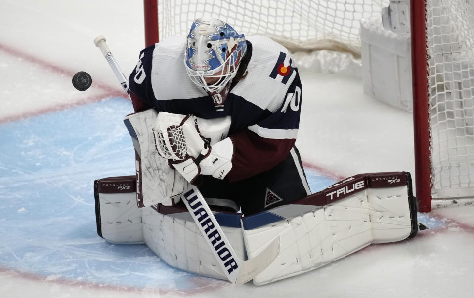 Colorado Avalanche goaltender Alexandar Georgiev stops a shot off the stick of a Minnesota Wild player in the first period of an NHL hockey game Wednesday, March 29, 2023, in Denver. (AP Photo/David Zalubowski)