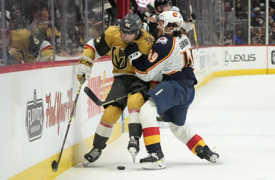 Colorado Avalanche defenseman Samuel Girard, right, checks Vegas Golden Knights right wing Jonas Rondbjerg in the second period of an NHL hockey game Monday, Jan. 2, 2023, in Denver. (AP Photo/David Zalubowski)