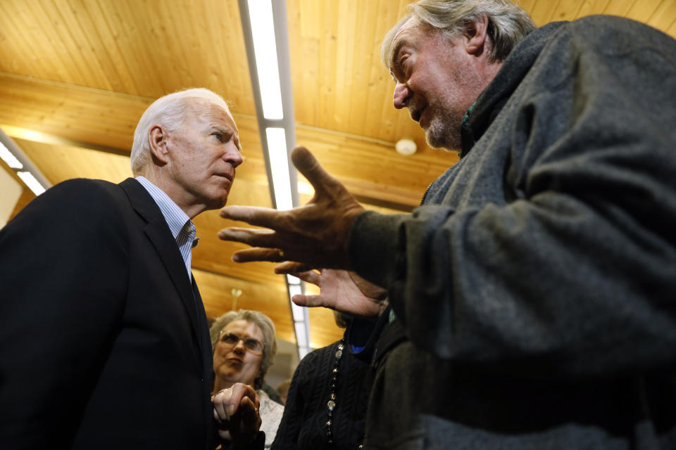 Democratic presidential candidate former Vice President Joe Biden talks with an audience member during a bus tour stop at Water's Edge Nature Center, Monday, Dec. 2, 2019, in Algona, Iowa. (AP Photo/Charlie Neibergall)