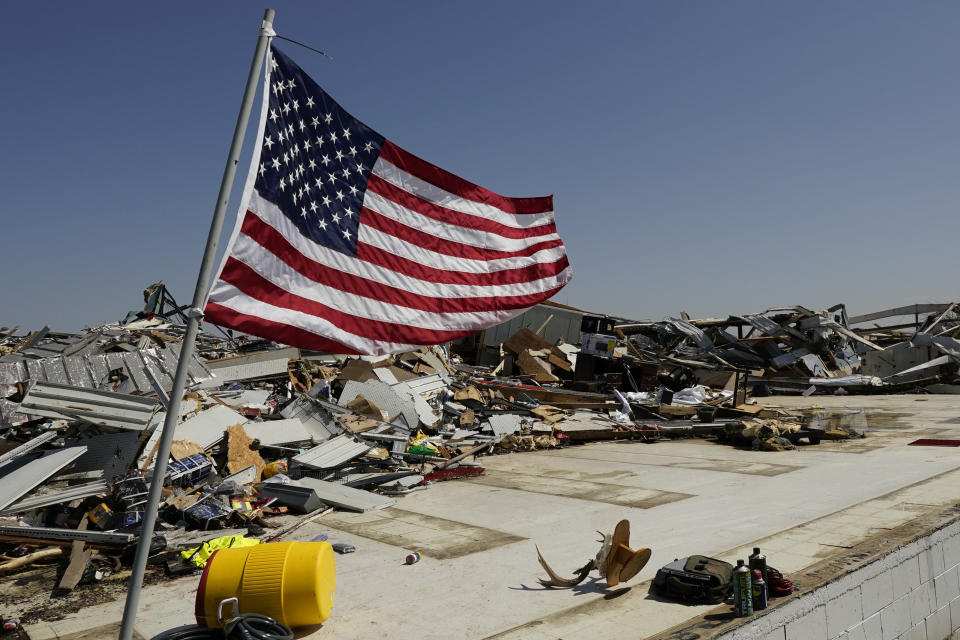 An American flag files on the slab of what was a hardware store in Rolling Fork, Miss., Saturday morning, March 25, 2023. Emergency officials in Mississippi say several people have been killed by tornadoes that tore through the state on Friday night, destroying buildings and knocking out power as severe weather produced hail the size of golf balls moved through several southern states. (AP Photo/Rogelio V. Solis)