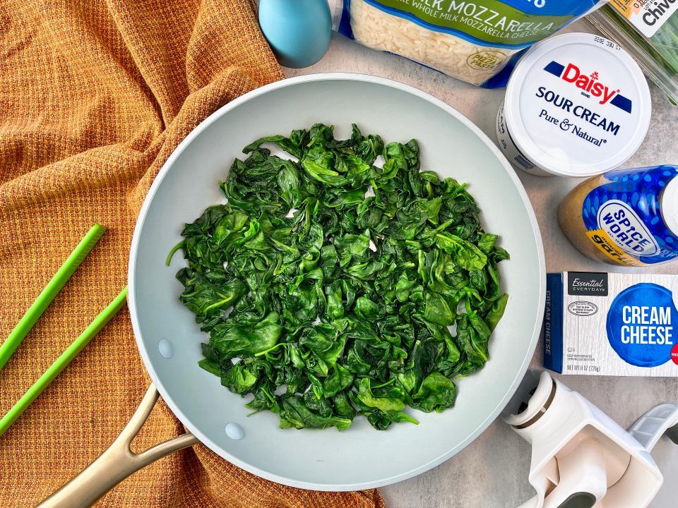 All you need to make the ultimate spinach dip is the sauted spinach and garlic, cheese and sour cream.