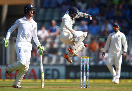 Cricket - India v England - Fourth Test cricket match - Wankhede Stadium, Mumbai, India - 8/12/16. India's Parthiv Patel (C) catches the ball as England's Keaton Jennings runs between wickets. REUTERS/Danish Siddiqui
