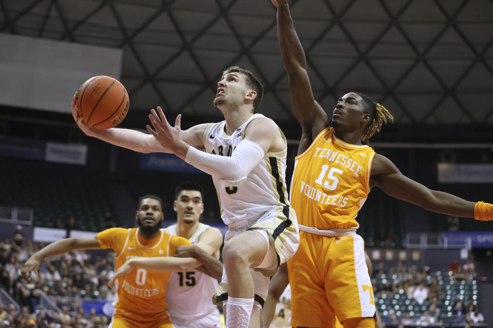 FILE - Purdue guard Braden Smith goes to the basket while being guarded by Tennessee guard Jahmai Mashack (15) during the first half of an NCAA college basketball game Tuesday, Nov. 21, 2023, in Honolulu. Smith was selected to the AP All-Big Ten first team in voting released Tuesday, March 12, 2024.(AP Photo/Marco Garcia, File)