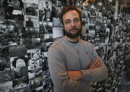 In this Thursday, Oct. 11, 2018, photo Evan Sharp, Pinterest co-founder and chief product officer, poses for a photo in his office beside a wall of pinned photos he has taken at Pinterest headquarters in San Francisco. “Social media is about sharing what you are doing with other people,” said Sharp. “Pinterest isn't about sharing. It's mostly about yourself, your dreams, your ideas you want for your future.” (AP Photo/Ben Margot)