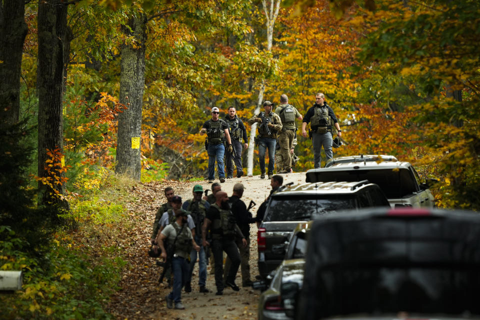 Law enforcement continue a manhunt in the aftermath of a mass shooting, in Durham, Maine, Friday, Oct. 27, 2023. Authorities are scouring hundreds of acres of family-owned property, sending dive teams to the bottom of a river and scrutinizing a possible suicide note in the second day of their intensive search for an Army reservist accused of fatally shooting several people in Maine.(AP Photo/Matt Rourke)