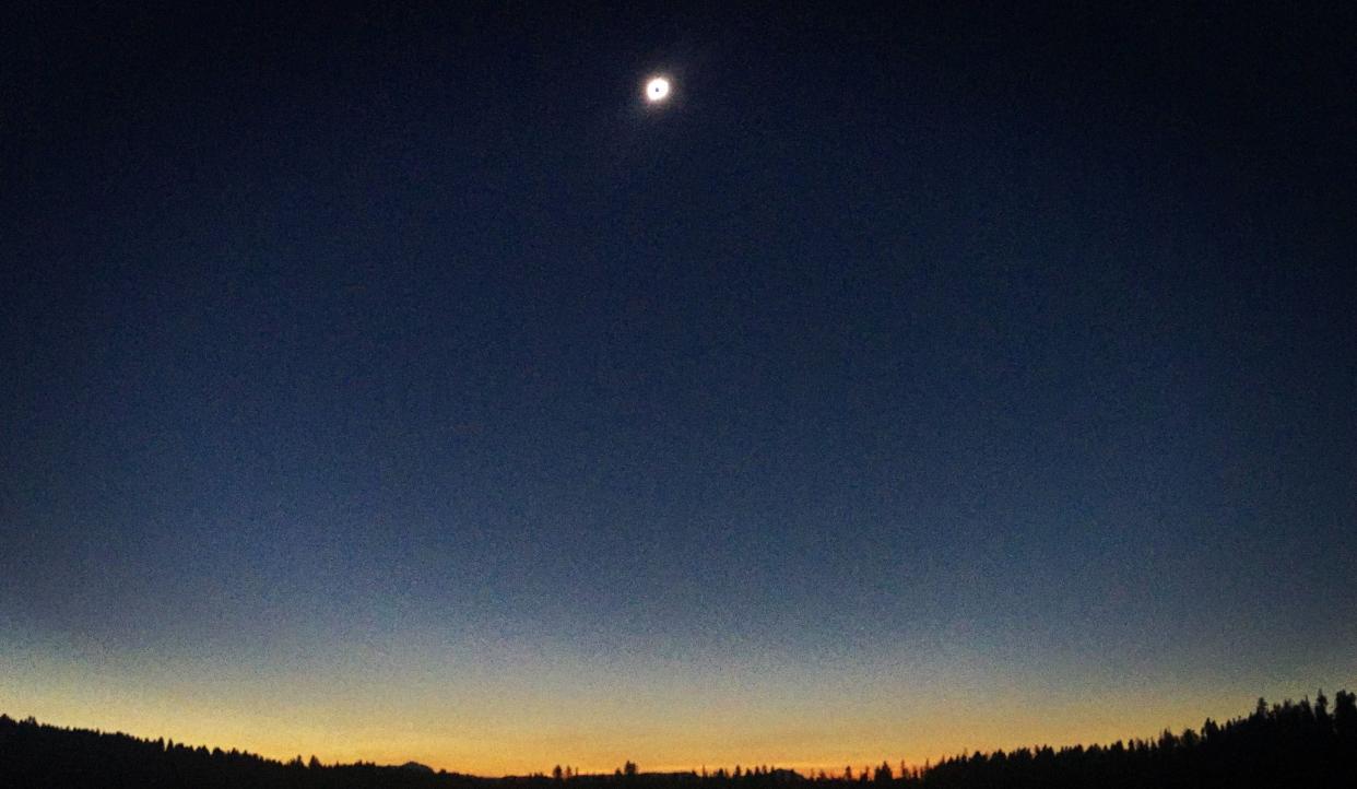 In 2017, people visiting Grand Teton National Park watched as the sky grew dark just before noon during the total solar eclipse. This photo was captured by RMSC Planetarium Director Jim Bader a few moments before totality.