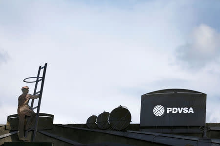 FILE PHOTO: The logo of the Venezuelan oil company PDVSA and cut-outs depicting oil facilities are seen on a building of the company in Caracas, Venezuela July 21, 2016. REUTERS/Carlos Garcia Rawlins/File Photo