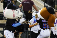 Mr. and Mrs. Met play trumpets as New York Mets reliever Edwin Diaz approaches the pitcher's mound to start the ninth inning of a baseball game against the Philadelphia Phillies, Friday, Aug. 12, 2022, in New York. (AP Photo/Frank Franklin II)