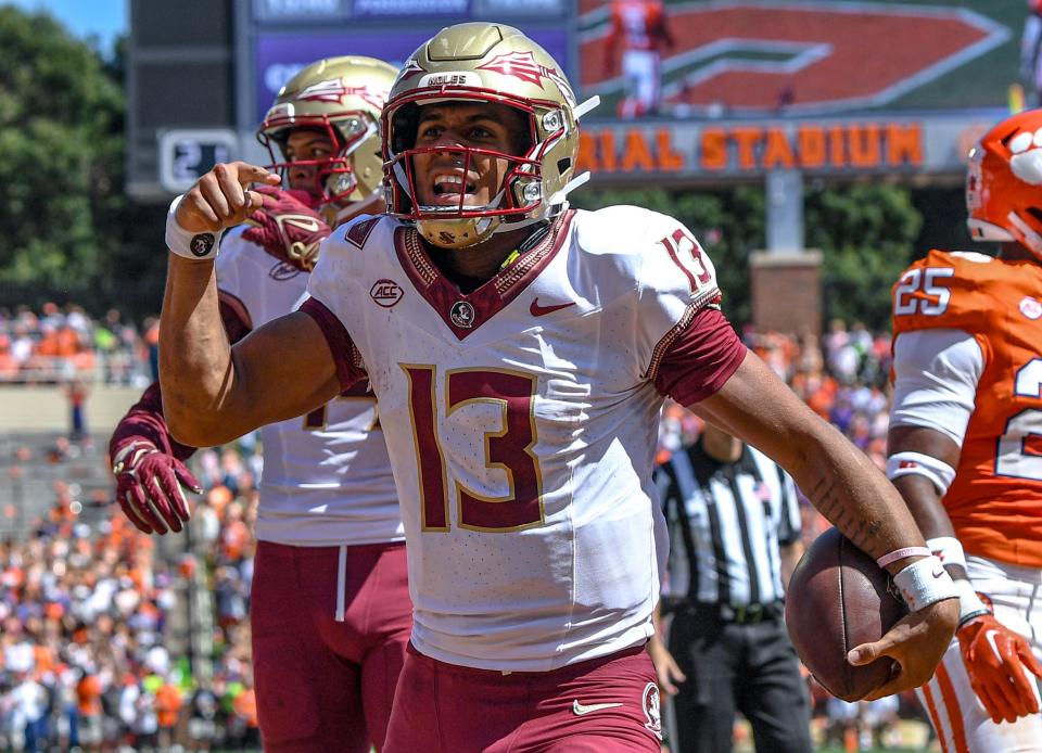 Florida State University quarterback Jordan Travis (13) reacts after scoring against Clemson during the second quarter Sep 23, 2023; Clemson, South Carolina, USA; at Memorial Stadium.