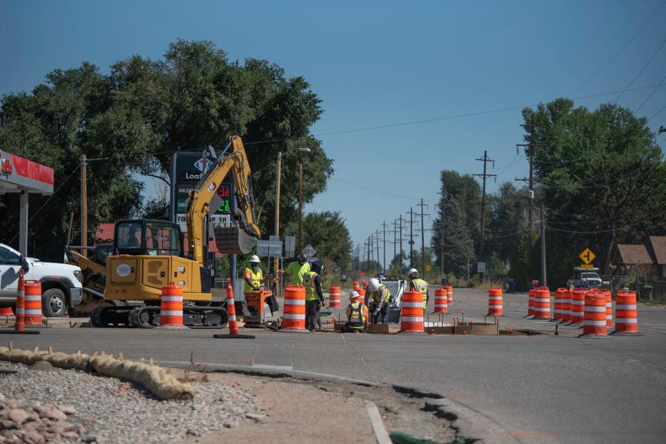 Construction crews work at the intersection of U.S. Highway 50 Business and 36th Lane on Wednesday, September 27, 2023.