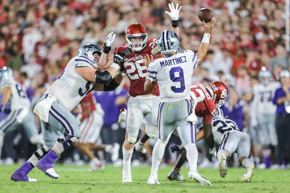 Kansas State's Adrian Martinez (9) throws a pass as Oklahoma's Danny Stutsman (28) attempts to swat at the ball in the third quarter during a college football game between the University of Oklahoma Sooners (OU) and the Kansas State Wildcats at Gaylord Family - Oklahoma Memorial Stadium in Norman, Okla., Saturday, Sept. 24, 2022. Kasnas State won 41-34.