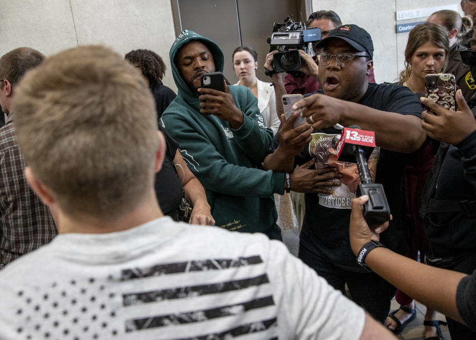 Supporters for Patrick Lyoya exchange words with supporters for Grand Rapids police officer Christopher Schurr inside a hallway after the arraignment of Grand Rapids police officer Christopher Schurr Friday, June 10, 2022 in Grand Rapids, Mich. A judge facing a packed courtroom set bond Friday at $100,000 for Schurr, a Michigan police officer charged with second-degree murder in the death of Patrick Lyoya, a Black man who was shot in the back of the head in April. (Cory Morse/The Grand Rapids Press via AP)