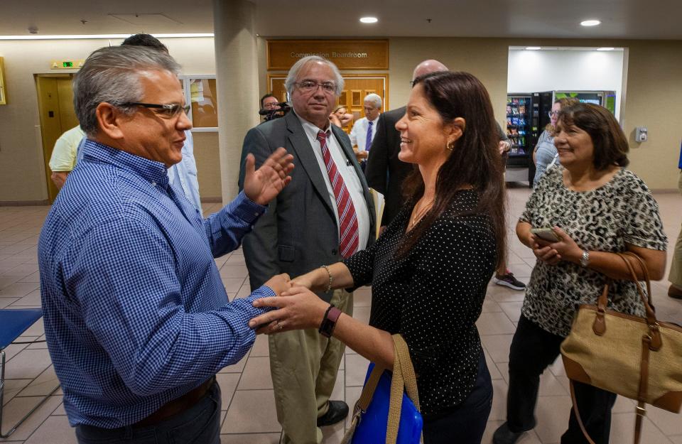 Ivan Rodriguez, left, thanks Laura Coyle, right, who led the neighborhood opposition to the proposed HCA hospital in South Lakeland.