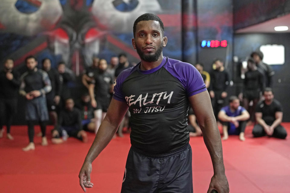 MMA coach Warsame Ibrahim attends a mixed martial arts practice session at Diesel Gym in the Docklands area of East London, Monday, March 25, 2024. The special sessions run by the nonprofit SCK Fitness are held at 10 p.m. during the Muslim holy month of Ramadan to accommodate dawn-to-dusk fasting. (AP Photo/Kin Cheung)