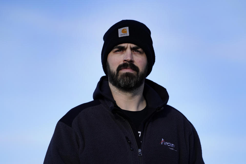 Stuart Hill, a United Auto Workers member who works at the General Motors Toledo Transmission Operations facility, poses in Toledo, Ohio, Tuesday, Feb. 2, 2021. At 38 years old and a GM employee for five years, Hill is still decades from retirement. He wonders about the future of that plant and his role in it. “It’s something that’s in the back of my mind," Hill said. "Are they going to shut it down?” (AP Photo/Paul Sancya)