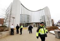 Court officers and Fall River, Mass., law enforcement officials stand outside Fall River Justice Center as the murder trial for former New England Patriots football player Aaron Hernandez is delayed by a bomb threat in Fall River, Massachusetts March 26, 2015. REUTERS/Steven Senne/Pool