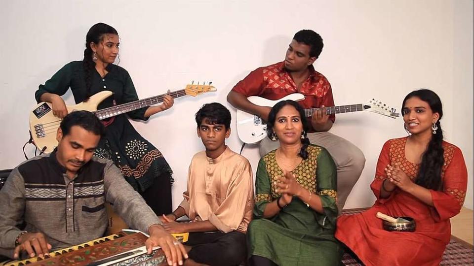 Savithri (sitting, in green) together with family members as they sing the Hari Raya song using a variety of musical instruments. — Facebook/UniqueArtsCultureandHeritageMalaysia