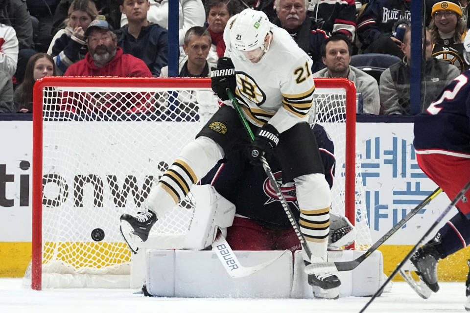 Boston Bruins left wing James van Riemsdyk (21) jumps out of the way of a shot in front of Columbus Blue Jackets goaltender Spencer Martin in the second period of an NHL hockey game Tuesday, Jan. 2, 2024, in Columbus, Ohio. (AP Photo/Sue Ogrocki)