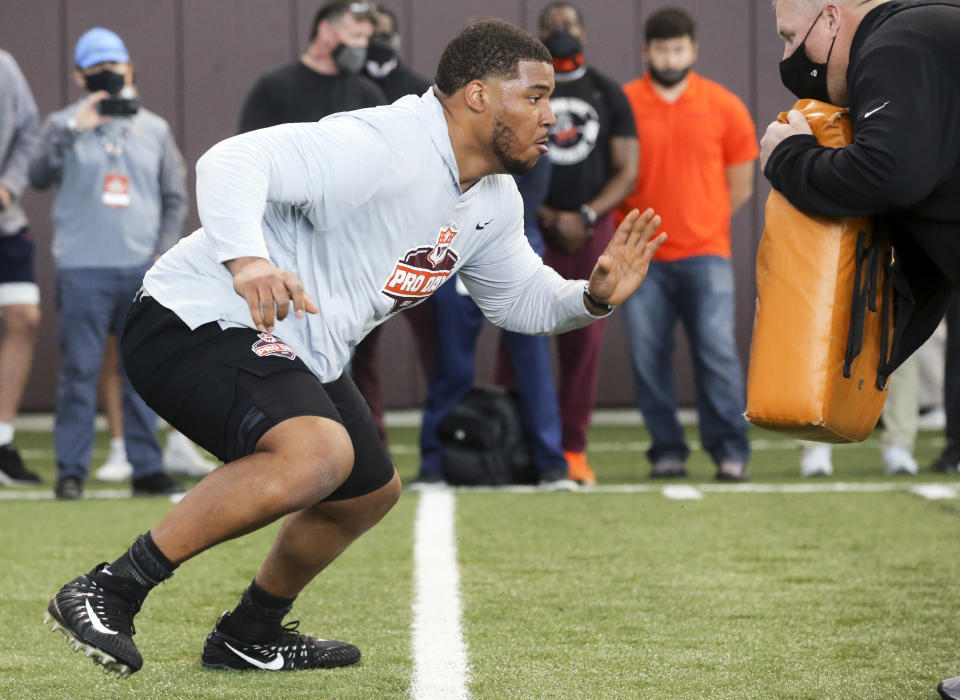 Christian Darrisaw runs a drill Virginia Tech pro day, attended by NFL scouts. (AP Photo/Matt Gentry)