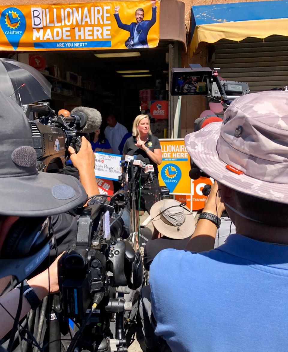 California Lottery spokeswoman Carolyn Becker speaks at a news conference in July 2023 outside a downtown Los Angeles minimart where a jackpot-winning Powerball ticket was sold worth more than $1 billion.