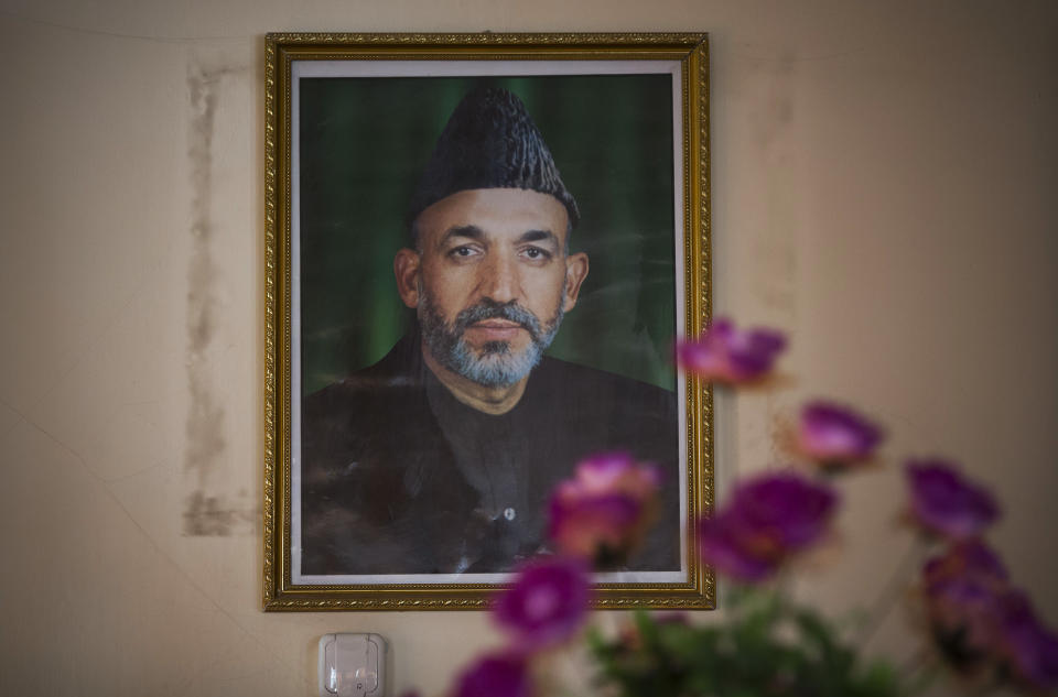 In this Saturday, March 29, 2014 photo, a picture of Afghan President Hamid Karzai hangs on a wall in the main room of the district municipality in eastern Kabul. Afghans go to the polls April 5, 2014 to choose a new president, and that in itself may one day be considered Karzai’s greatest achievement. (AP Photo/Anja Niedringhaus)