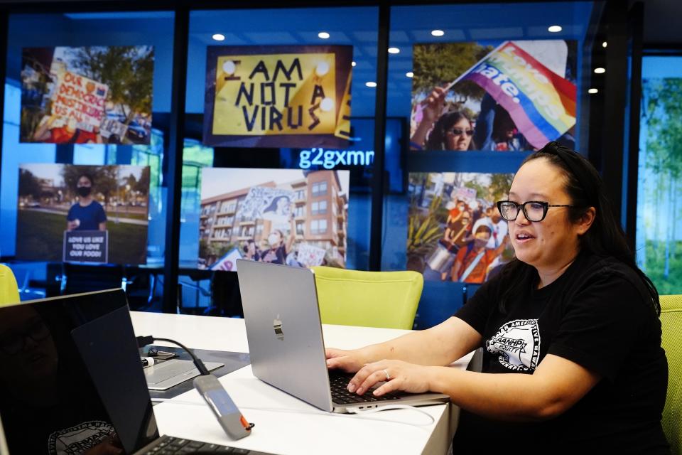 Jennifer Chau, director of the Arizona Asian American Native Hawaiian and Pacific Islander For Equity Coalition, works at her office Friday, April 8, 2022, in Tempe, Ariz. (AP Photo/Ross D. Franklin)