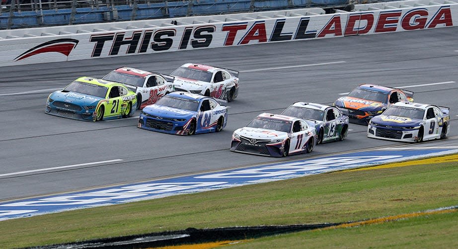 TALLADEGA, ALABAMA - OCTOBER 04: Denny Hamlin, driver of the #11 FedEx Express Toyota, William Byron, driver of the #24 Hendrickcars.com Chevrolet, and Matt DiBenedetto, driver of the #21 Menards/Tuscany Ford, lead the field during the NASCAR Cup Series YellaWood 500 at Talladega Superspeedway on October 04, 2020 in Talladega, Alabama. (Photo by Chris Graythen/Getty Images) | Getty Images