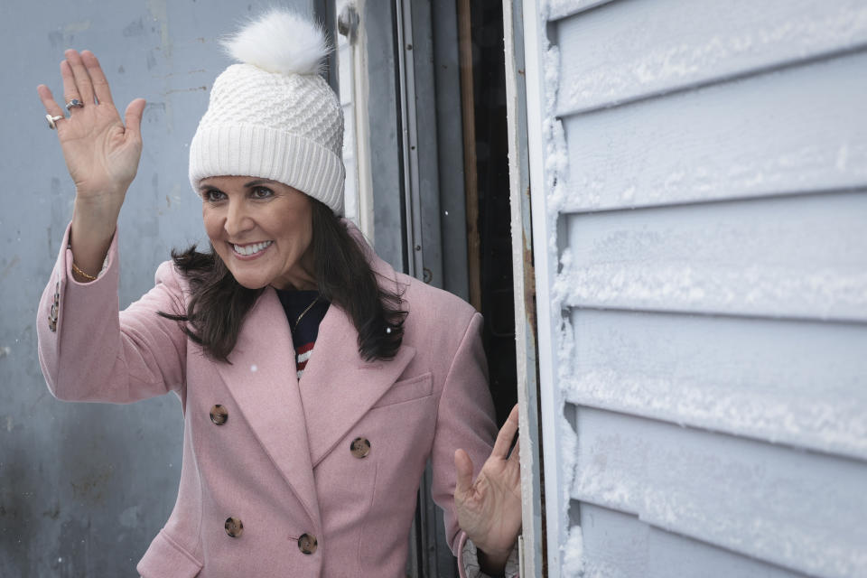 Closeup of Nikki Haley in a winter hat waving