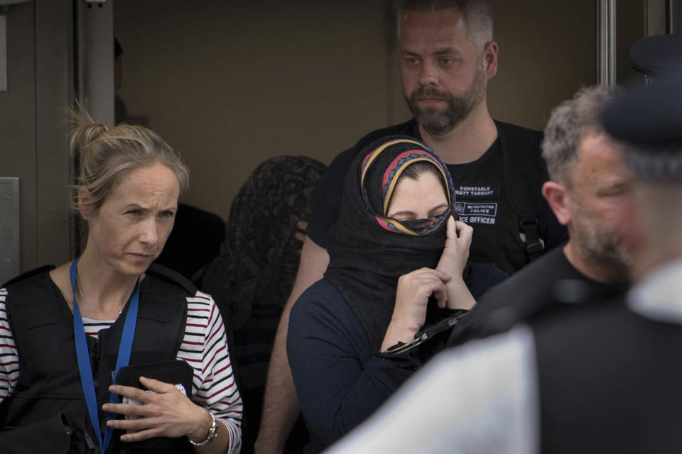 Police with woman in handcuffs