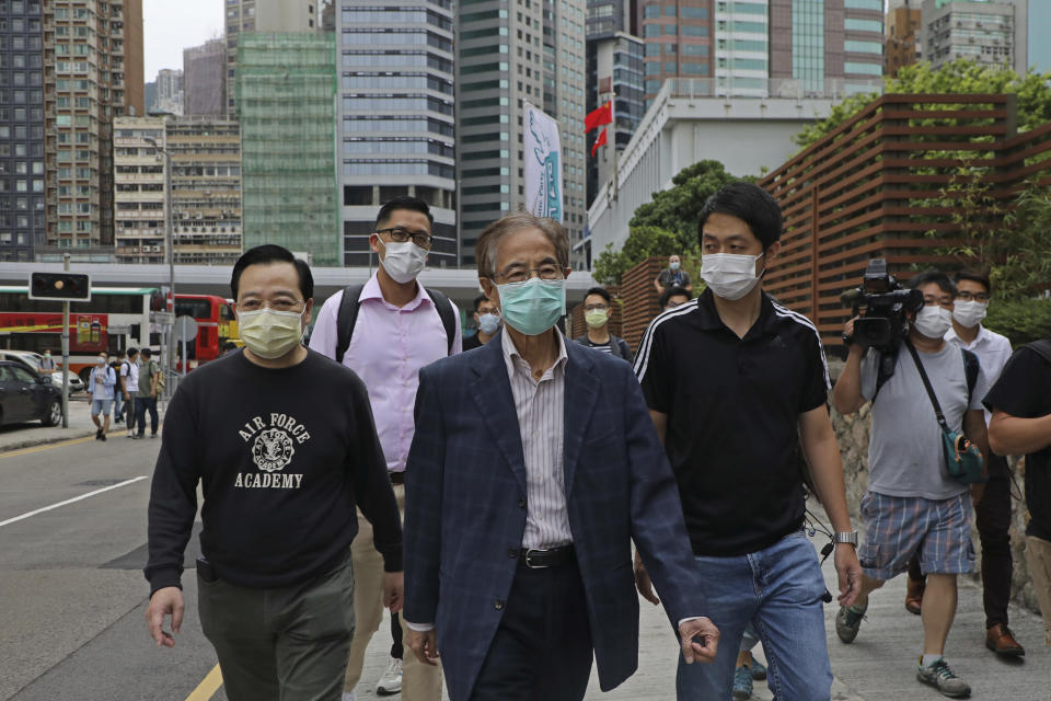 Former pro-democracy lawmaker Martin Lee, 81-year-old, center, leaves a police station in Hong Kong, Saturday, April 18, 2020. Hong Kong police arrested at least 14 pro-democracy lawmakers and activists on Saturday on charges of joining unlawful protests last year calling for reforms. (AP Photo/Kin Cheung)