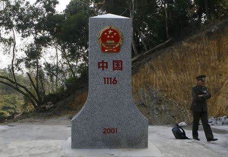 A Vietnamese border guard stands next to a border marker between China's Guangxi and Vietnam's Lang Son provinces in this January 13, 2009 file photo. REUTERS/Kham/Files