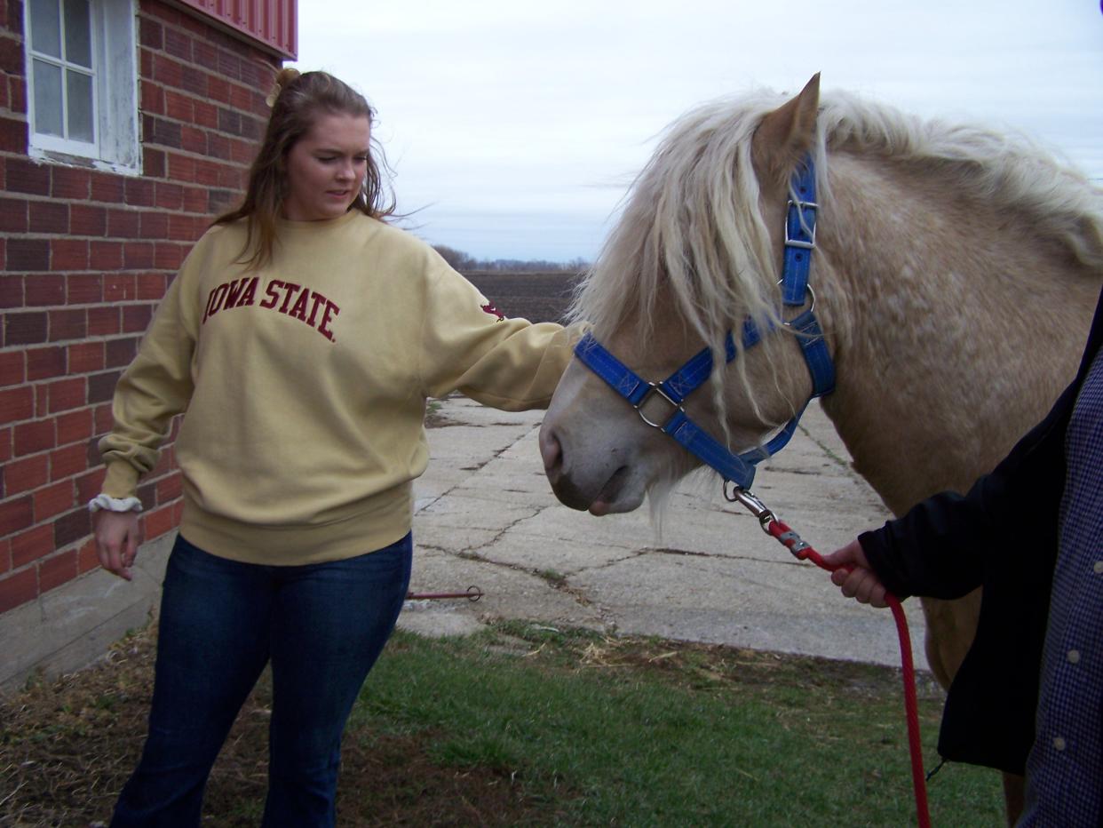 Emma Stalzer with Kinnick, an American Cream Draft Horse stallion.