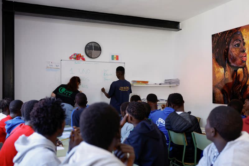 Minor migrants attend Spanish classes with teacher Alejandra Rodriguez at the residence where they live in Valverde.